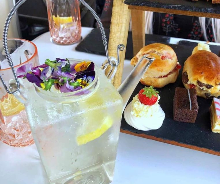 Edinburgh: Vintage Bus Tour with Afternoon Tea or Gin - Getting on board at Waterloo Place: seats, shared tables, and the best spots